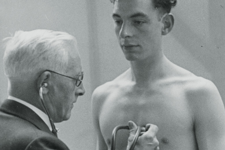 Young man having heart rate checked by doctor Young man having heart rate checked by doctor